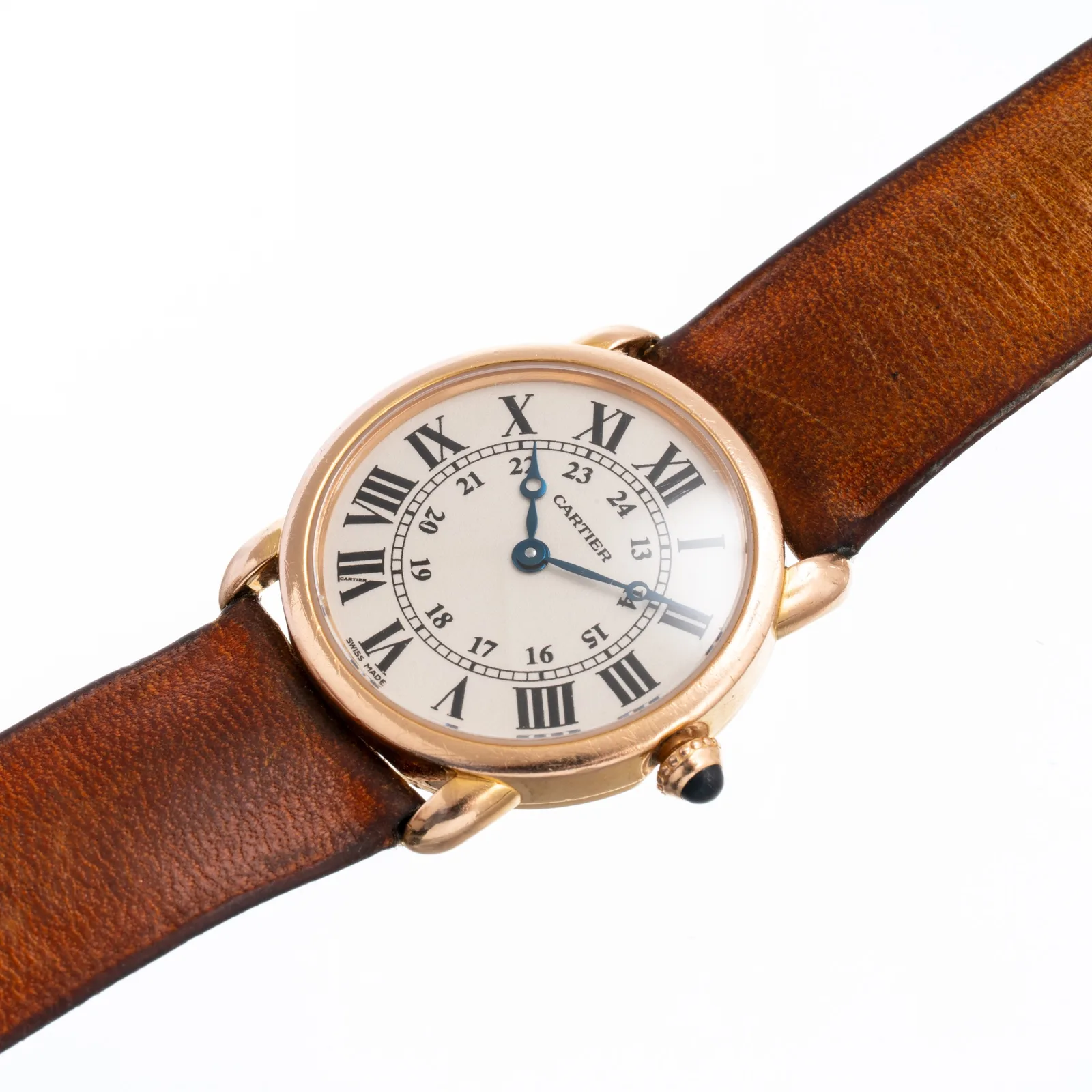 Cartier Ronde in rose gold with a cream dial, Roman numerals, and a sapphire cabochon crown