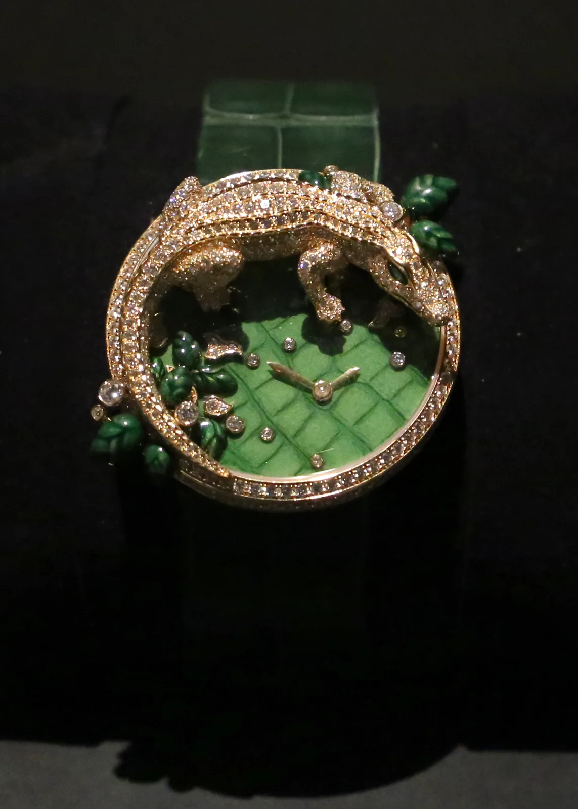 Cartier Les Indomptables clip watch with a diamond crocodile over a green circular dial