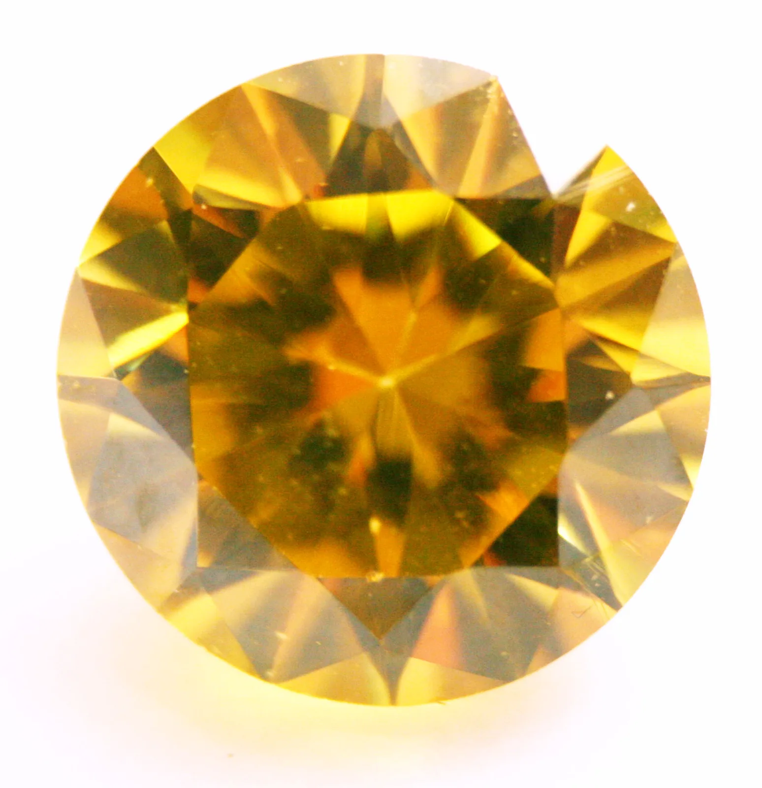 Round yellow cubic zirconia on a dark ground, the lower pavilion facets visible around the center