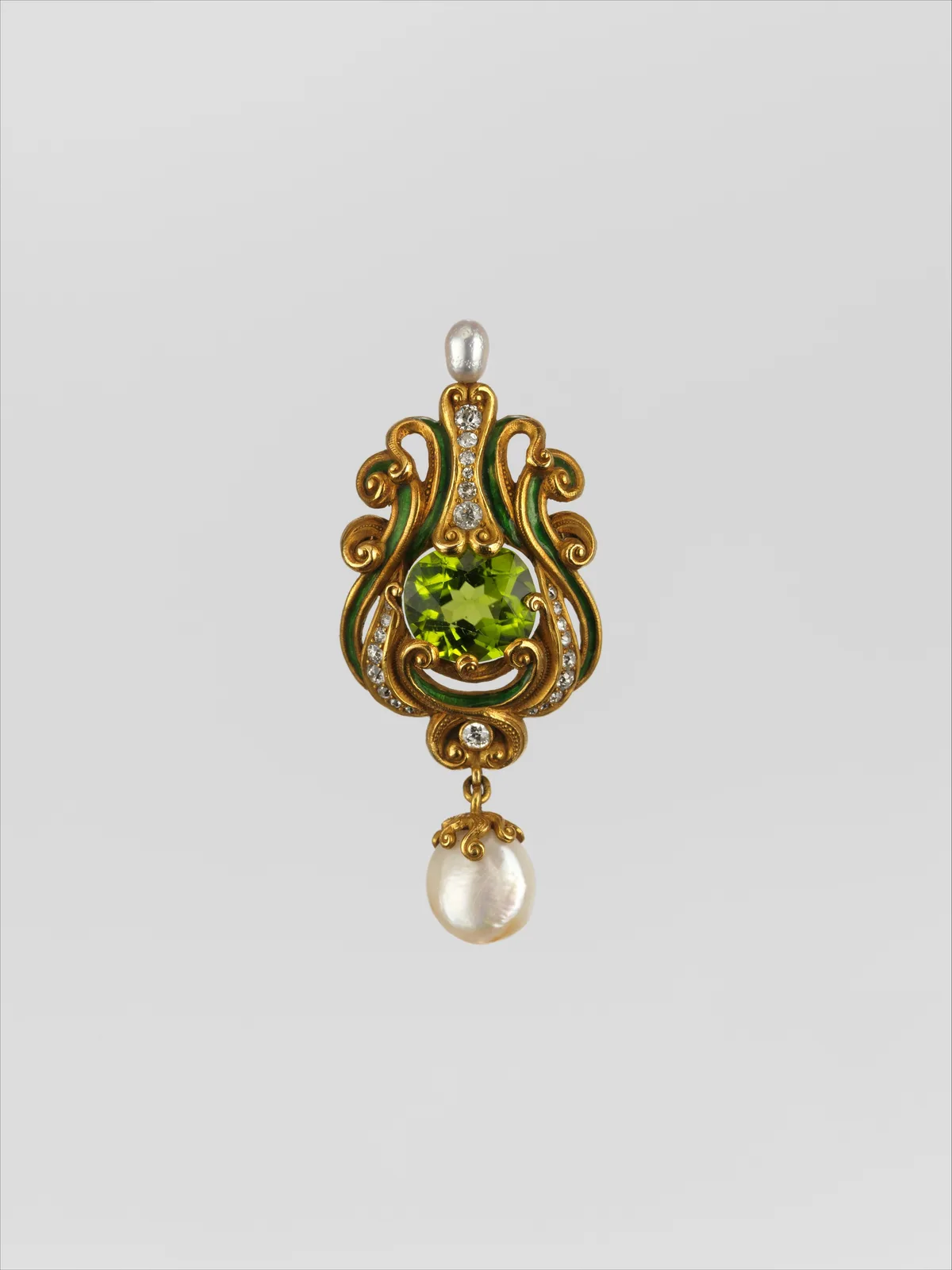 Marcus and Co. gold brooch with a round lime peridot in a scrolled gold frame, green enamel, diamonds, and a pearl drop