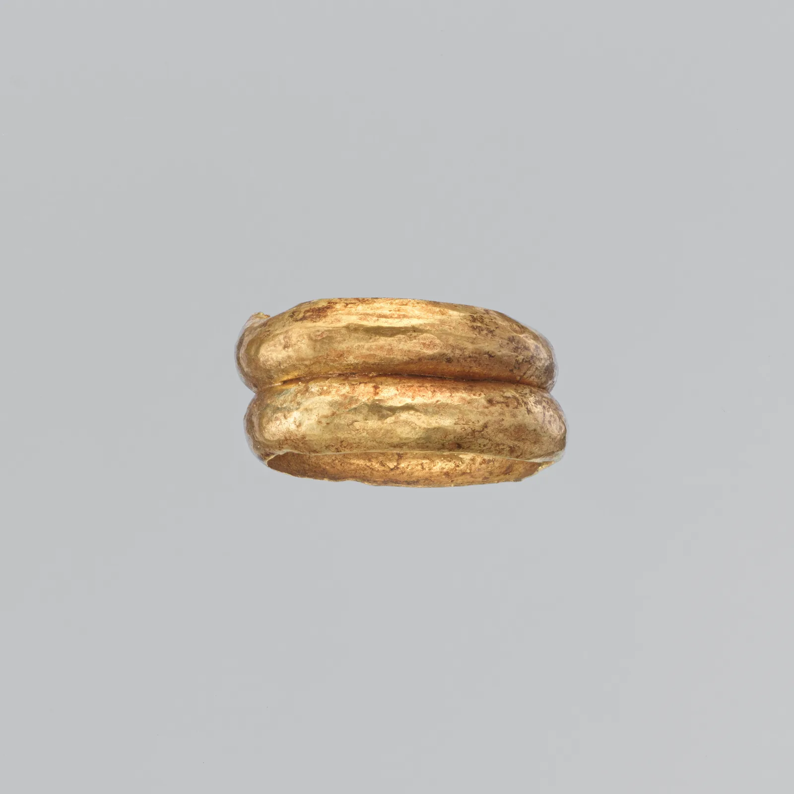 Cypriot gold finger ring formed as two rounded bands stacked and joined into one hoop