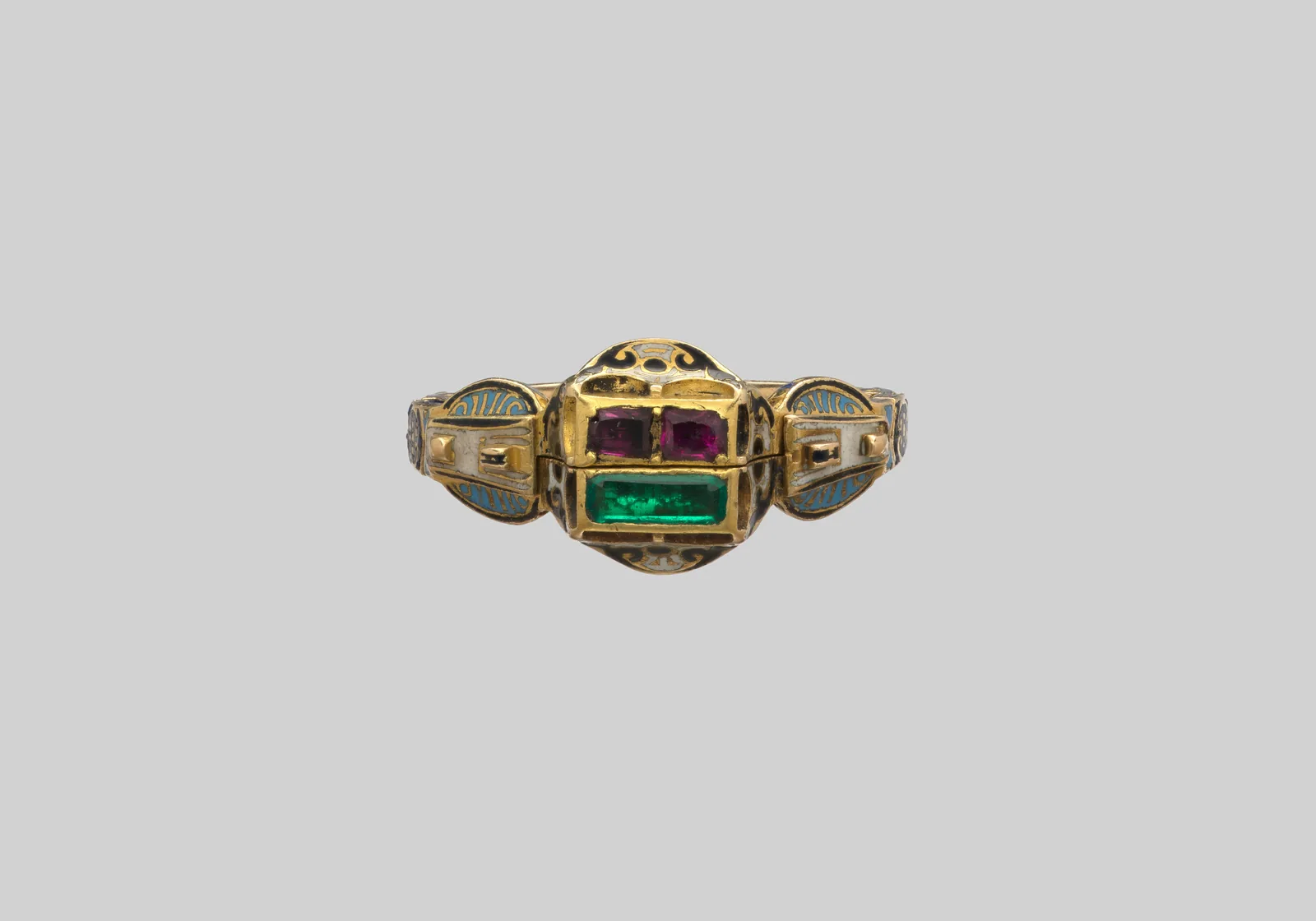Sixteenth-century gold gimmel ring whose two hoops meet as one bezel, two small rubies above a rectangular emerald