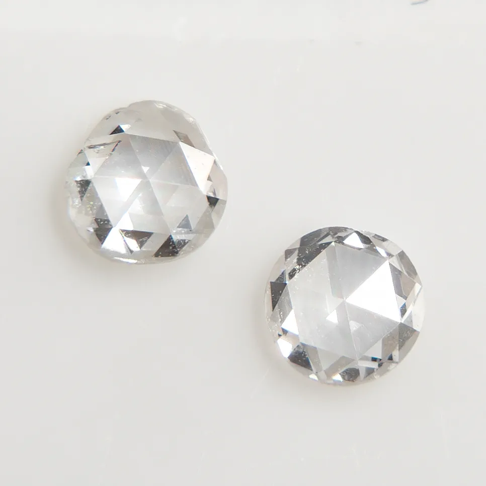 Two rose-cut diamonds on a black ground, each a low dome of triangular facets