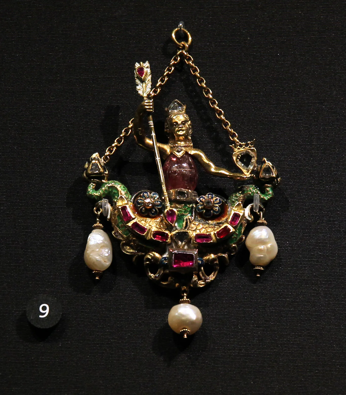 An Austro-Hungarian double-tailed mermaid pendant, the torso a pink tourmaline, with enamelled gold, diamonds, rubies, and baroque pearls