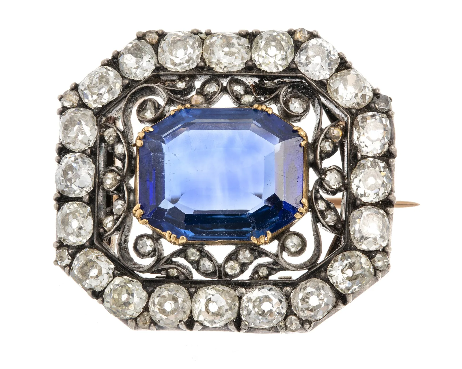 Nineteenth-century brooch with a large table-cut deep-blue sapphire held in gold and bordered by diamonds