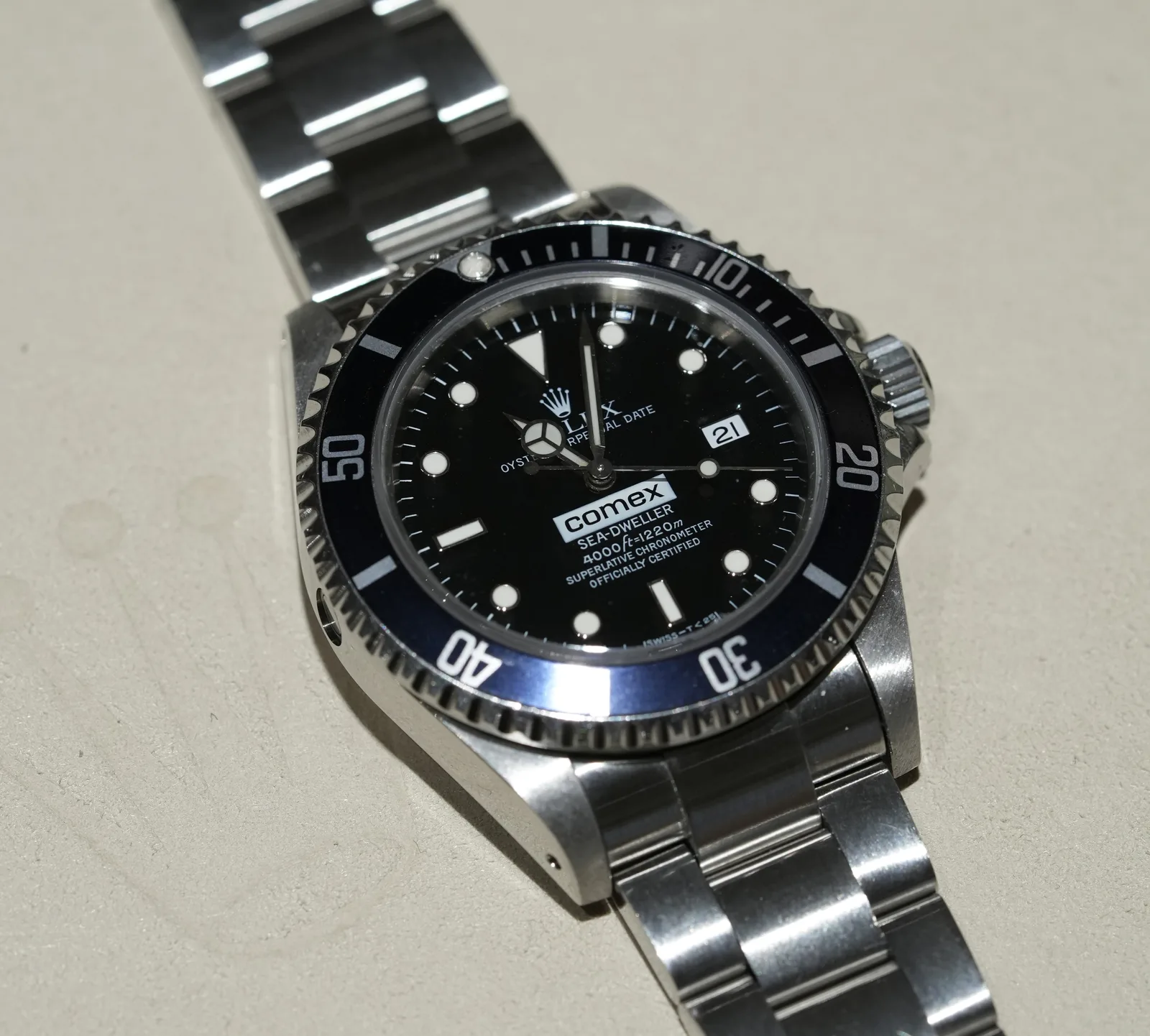A Rolex Comex Sea-Dweller with Comex on the dial, a date at three, and a helium valve at nine, shown off the wrist