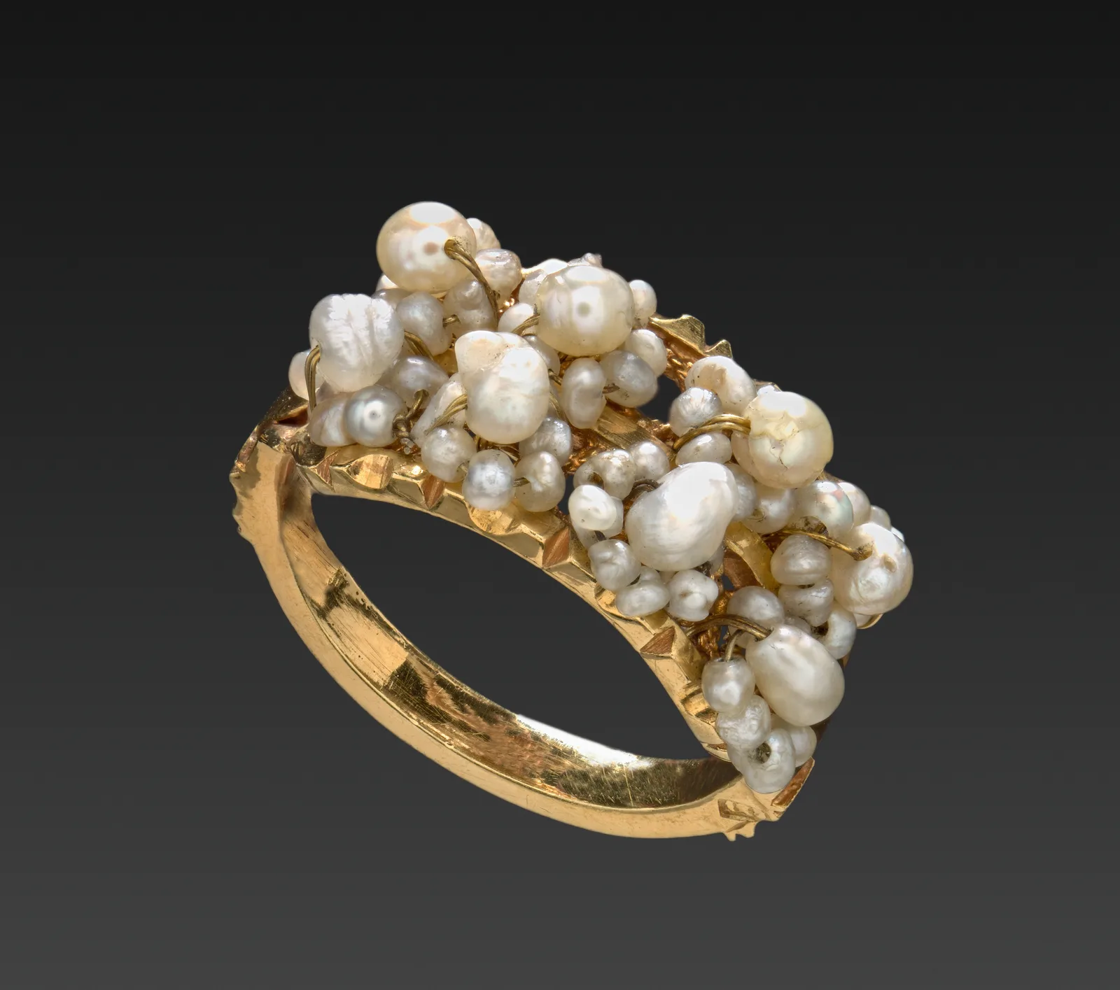 Late nineteenth-century gold ring with a cluster of seed pearls on top and a plain gold shank continuing beneath