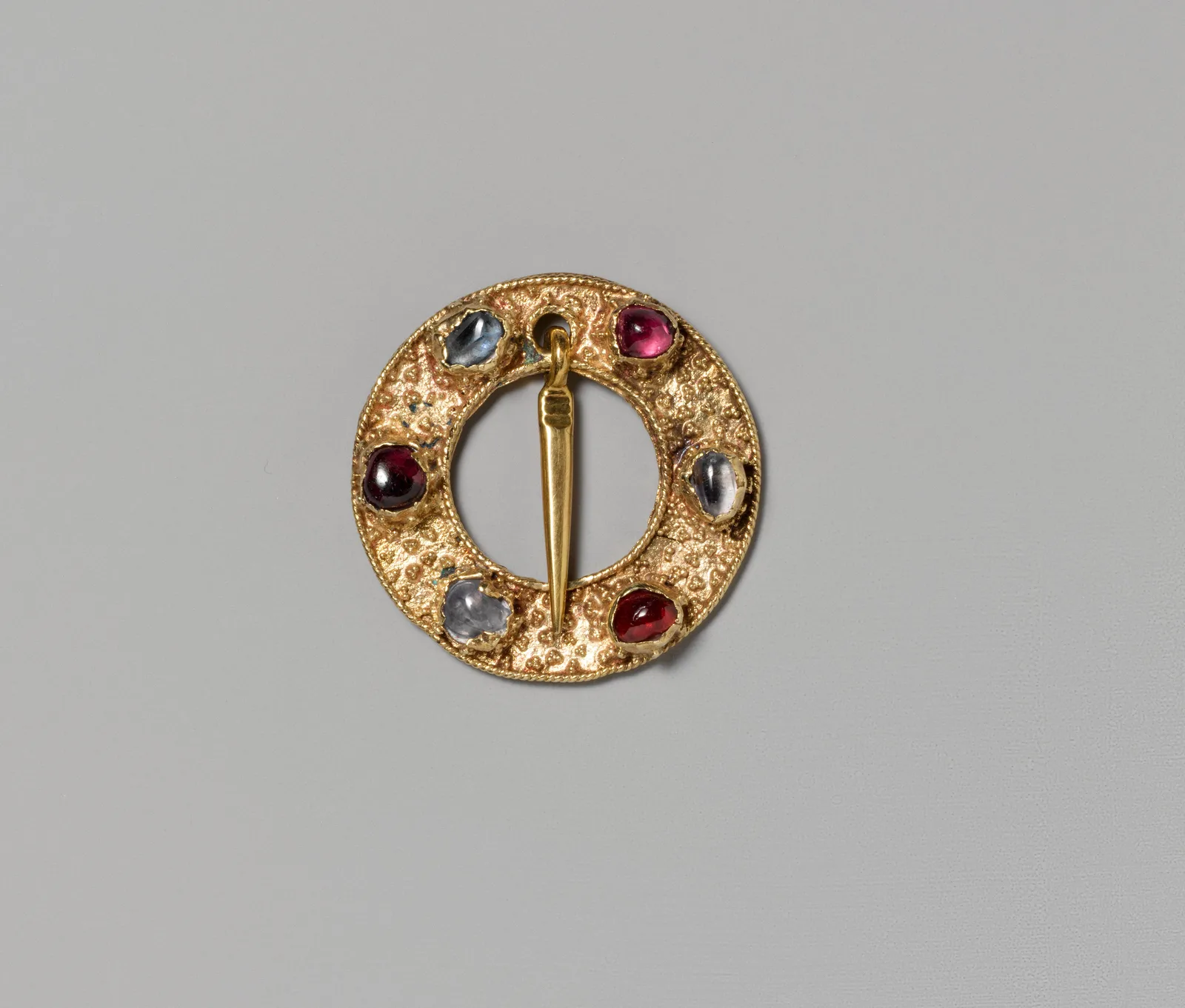 Fourteenth-century gold ring brooch set with spinels and sapphires in a small circular gold rim