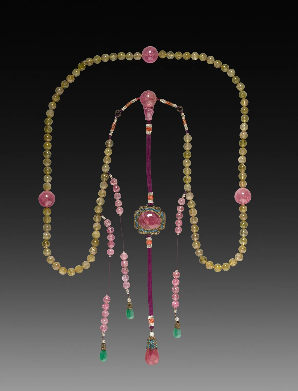 Qing court necklace of olive-green beads punctuated by large pink tourmaline spheres, a pink tourmaline plaque on a purple silk drop, and side strands ending in saturated green teardrops