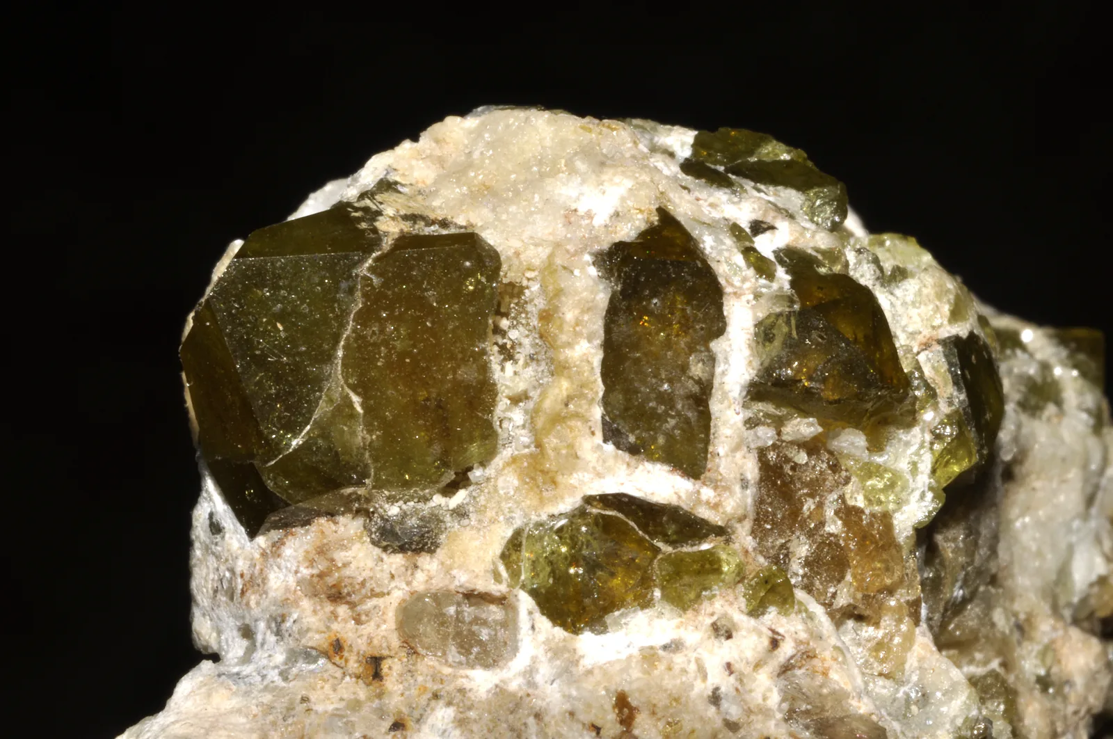 A single chrome-green tsavorite crystal from Madagascar, vivid and translucent, on a pale ground