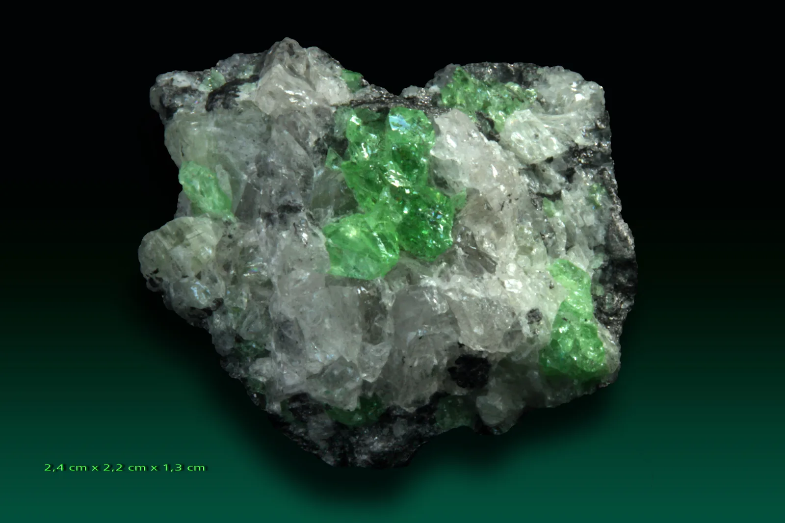 Vivid green tsavorite crystals in a dark matrix from the Merelani Hills, Tanzania