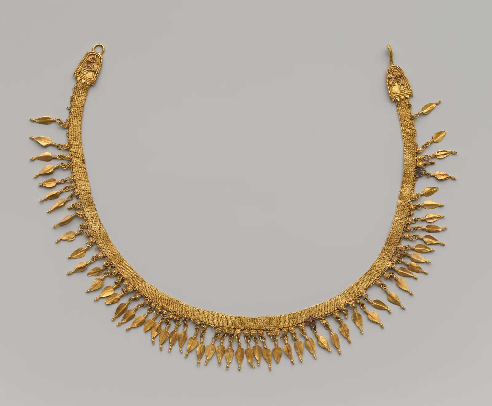 Late Classical Greek gold strap necklace of woven gold tape with beechnut pendants and rosettes along a flexible line