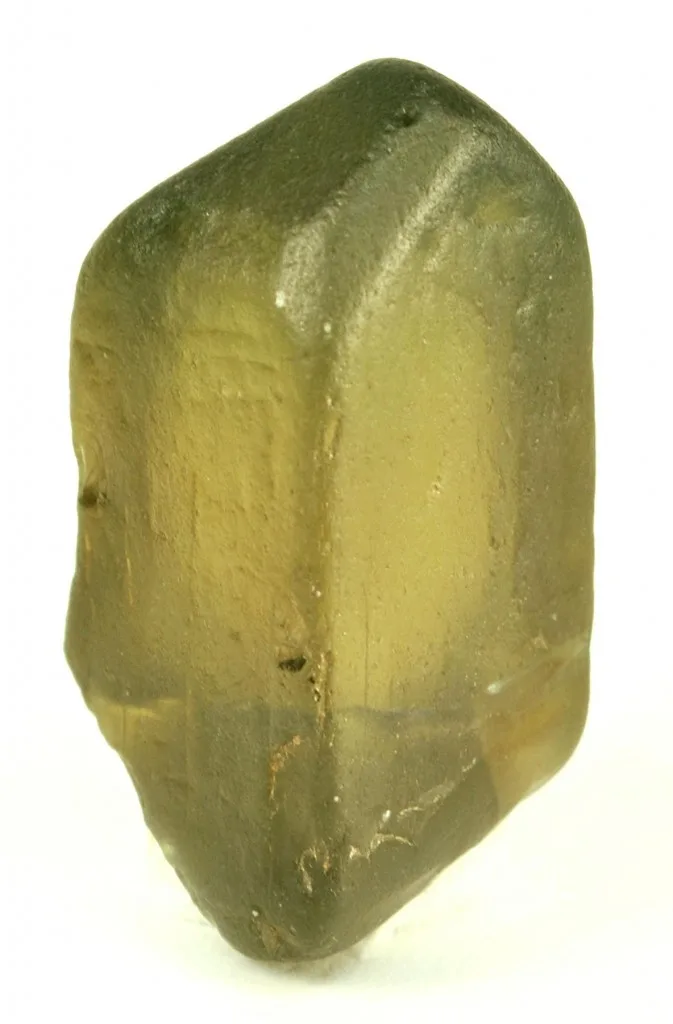 A transparent zircon crystal from Mogok, warm and gemmy, with a sharp termination on a dark ground